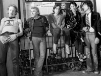 The Dead Boys  Stiv Bators, Jeff Mangum and Jimmy Zero on a metal fence with other band members.
